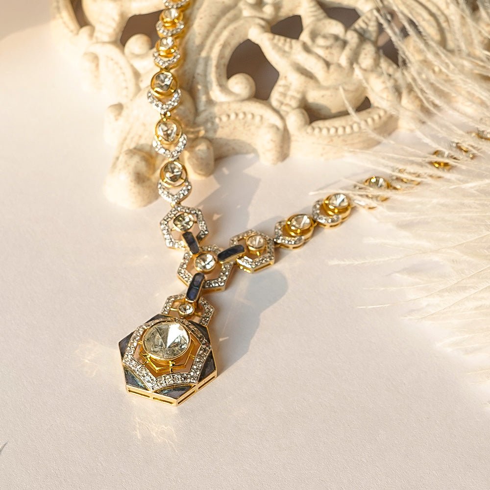 Flatlay of Mercurial Trine necklace with trinity pattern and radiant polki finish