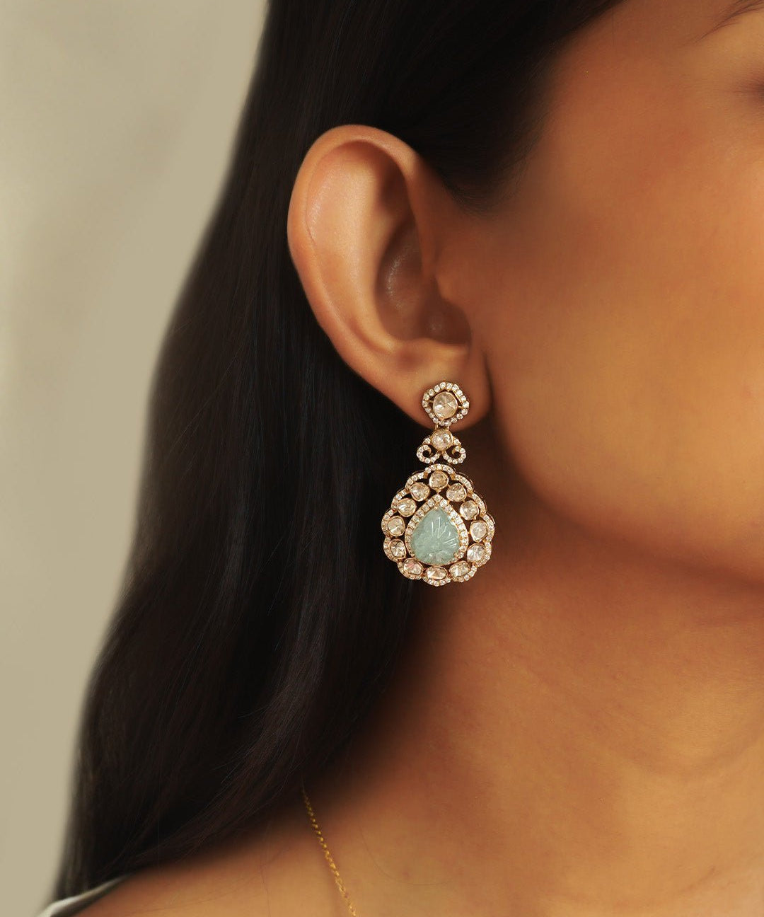 Subtle model shot featuring minimalistic Polki studs with pastel gemstone detailing.