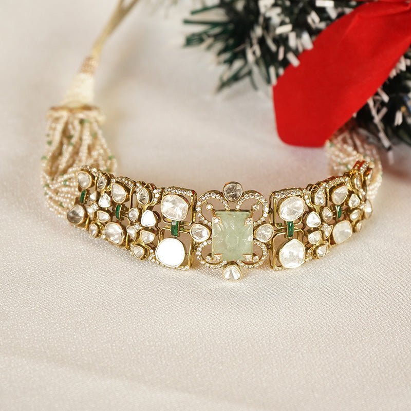 Flat image of Emerald Mirage Polki necklace with symmetrical design and radiant green accents