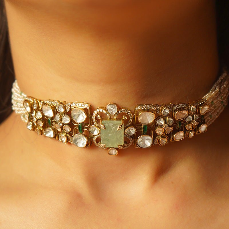 Emerald Mirage necklace draped on model, with lush emeralds and dazzling polki brilliance