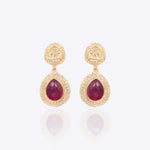 Oval ruby and Polki diamond drop earrings in 14K gold with a double-halo design.