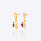 Oval ruby and Polki diamond drop earrings in 14K gold with a double-halo design.