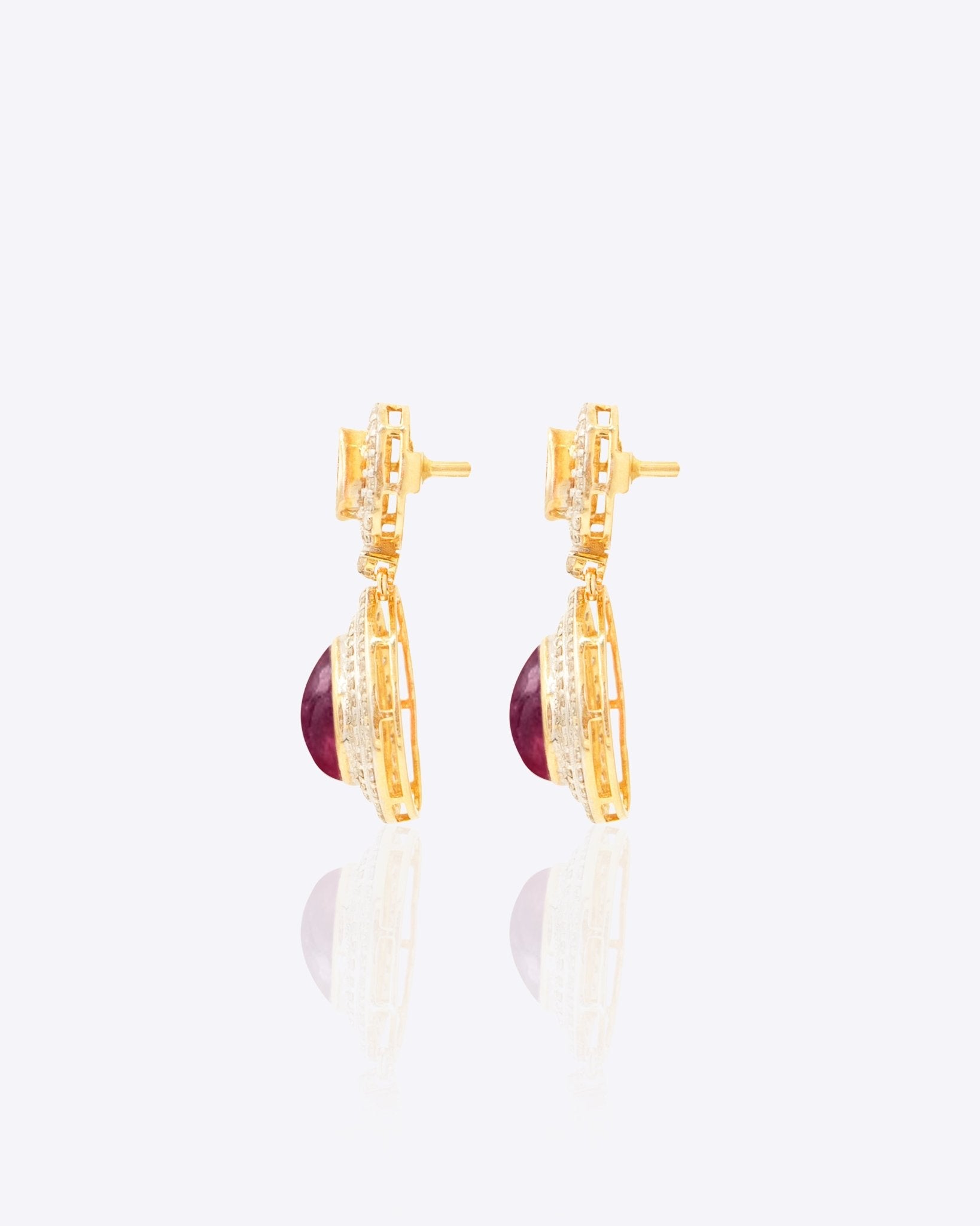 Oval ruby and Polki diamond drop earrings in 14K gold with a double-halo design.