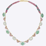 14K gold necklace with emerald accents and a half-butterfly design