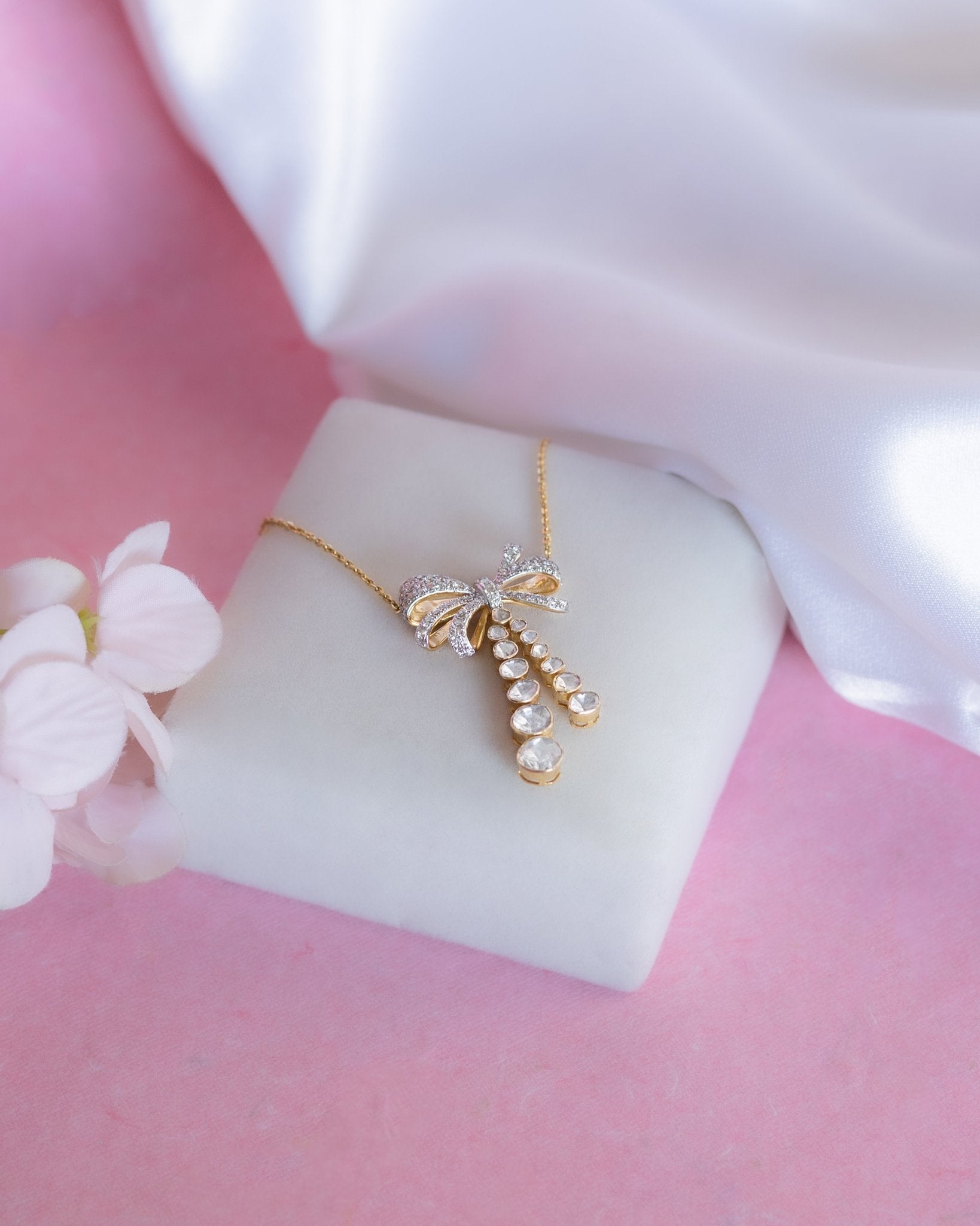 14kt gold necklace with delicate bow design and cascading drops