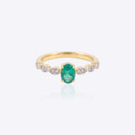 14K gold ring with a vivid emerald framed by diamonds