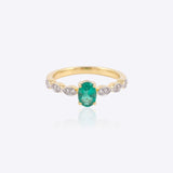 14K gold ring with a vivid emerald framed by diamonds
