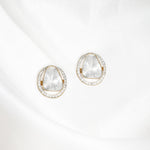 Circular golden frame earrings with gleaming diamond polki at center, exuding understated luxury