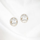 Circular golden frame earrings with gleaming diamond polki at center, exuding understated luxury