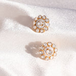 18K gold earrings with intricate floral forms, mesmerizing polki diamonds, and brilliant-cut diamond-adorned petals. 