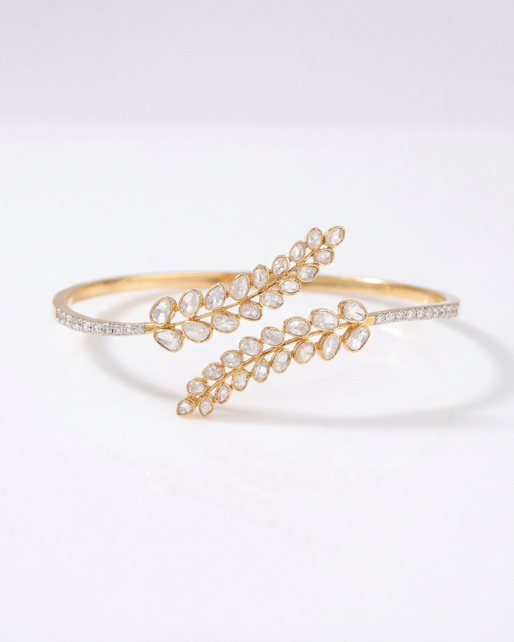 14K gold palm bracelet with a feather-inspired design and Polki accents