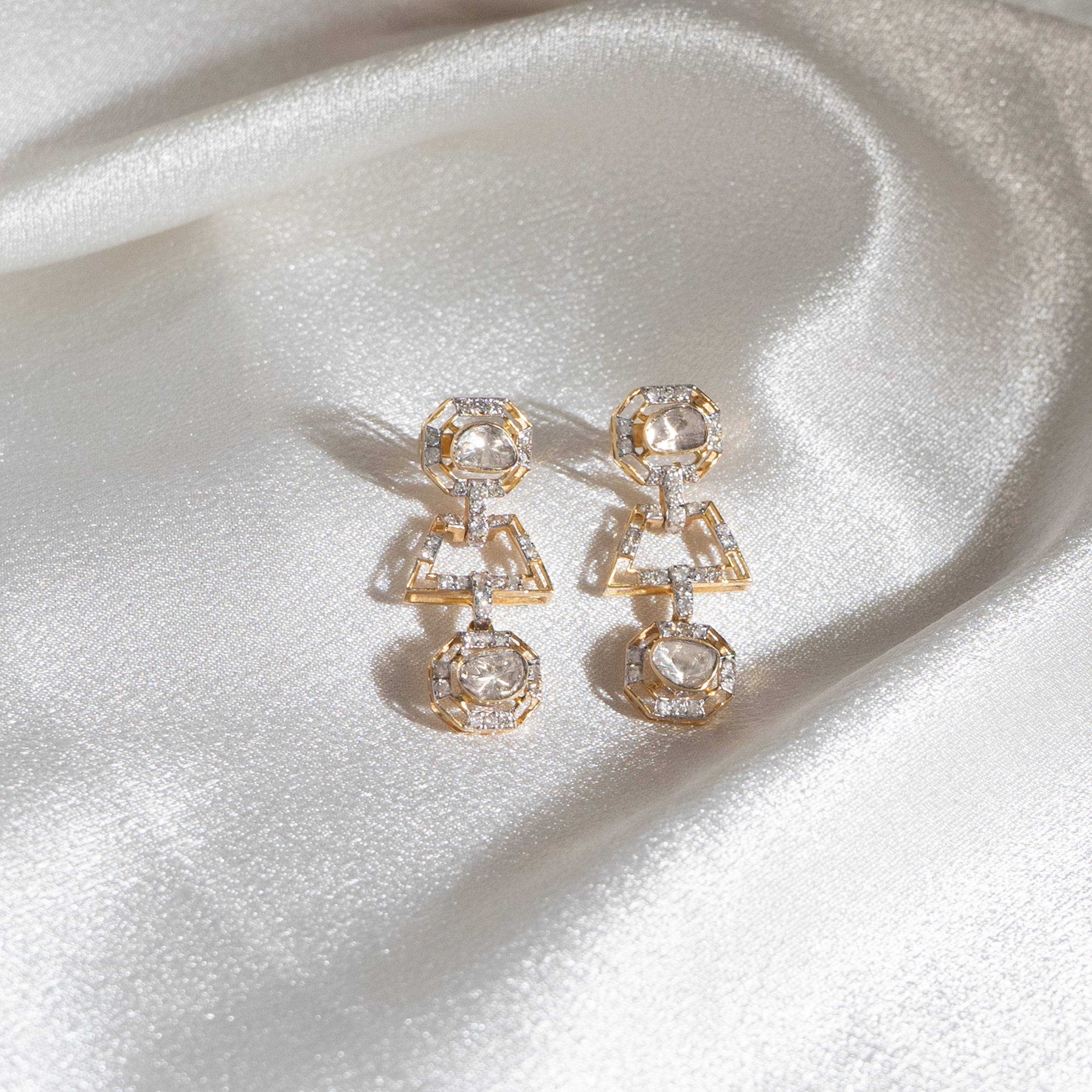 Crafted with utmost care, these dangling earrings feature a striking half-circle design adorned with raw polki diamonds.