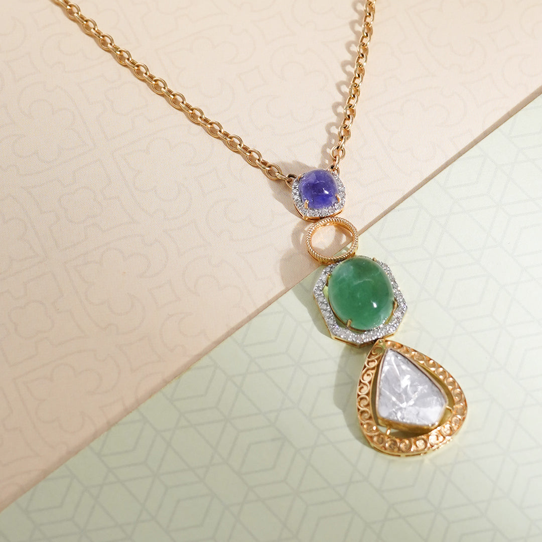 Pendant with radiant sapphire, lustrous emerald, and dazzling diamond polki in a golden cast.