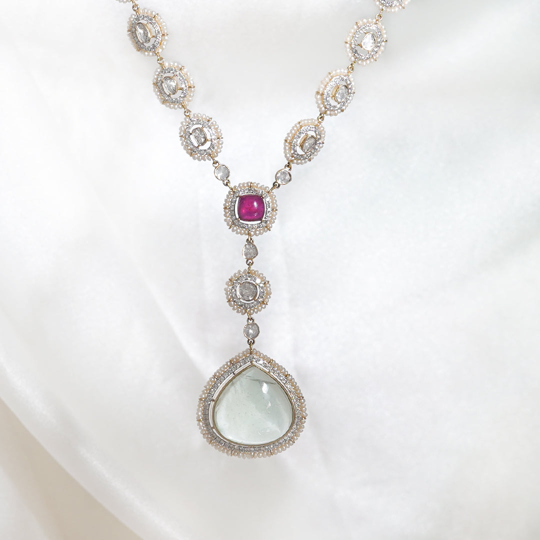 Polki Diamond Pendant features round polki diamonds, ruby, emerald, & golden framework.