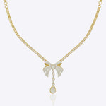 14kt gold choker necklace featuring intricate jali work and a central three-dimensional folded bow design.