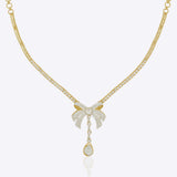 14kt gold choker necklace featuring intricate jali work and a central three-dimensional folded bow design.