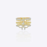 14K gold statement ring with layered bands, diamond-lined borders and a sculpted bow motif in a bold contemporary design.
