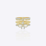 14K gold statement ring with layered bands, diamond-lined borders and a sculpted bow motif in a bold contemporary design.