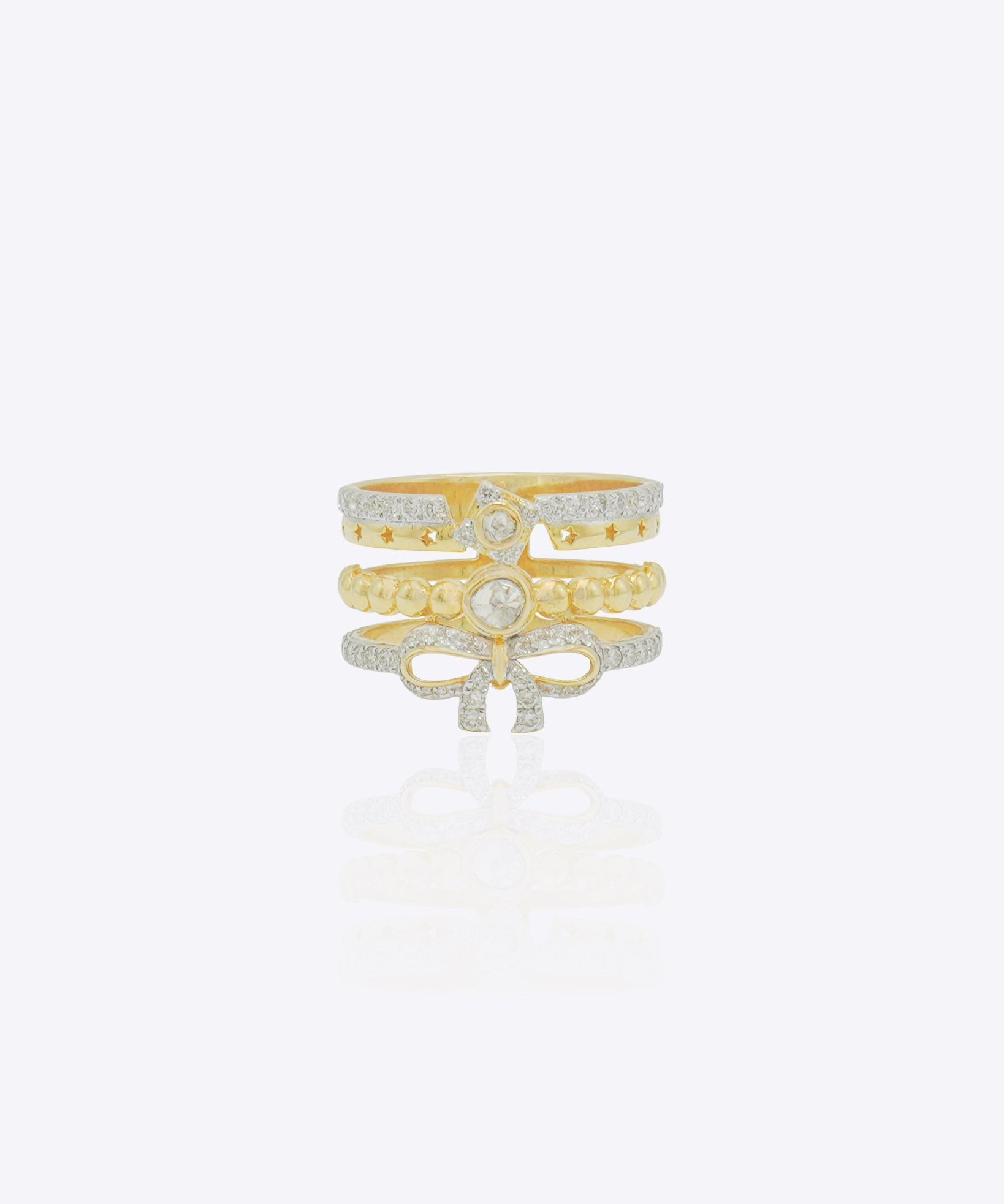 14K gold statement ring with layered bands, diamond-lined borders and a sculpted bow motif in a bold contemporary design.