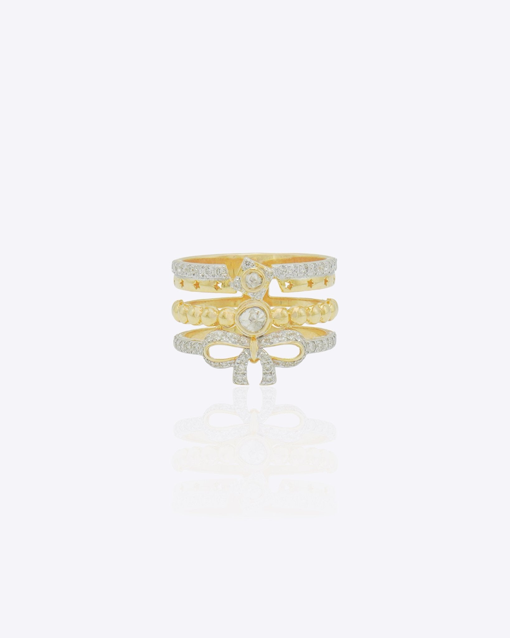 14K gold statement ring with layered bands, diamond-lined borders and a sculpted bow motif in a bold contemporary design.