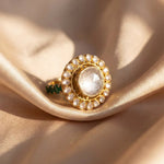 Sunburst Polki Ring in 14K gold with a central Polki halo of Zambian emeralds.