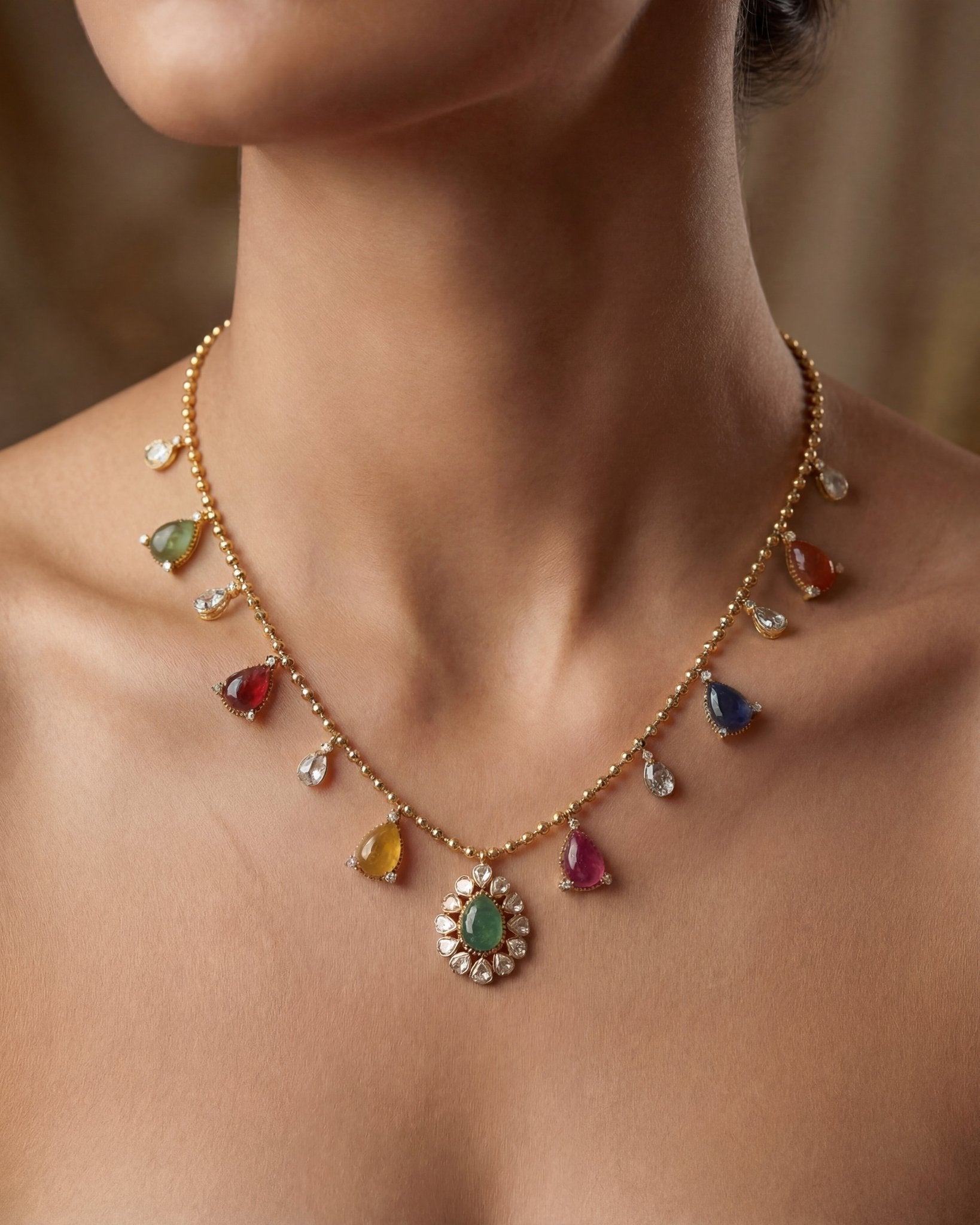 18k gold Navratna Grace necklace with colourful Navratna stones and drop detailing.