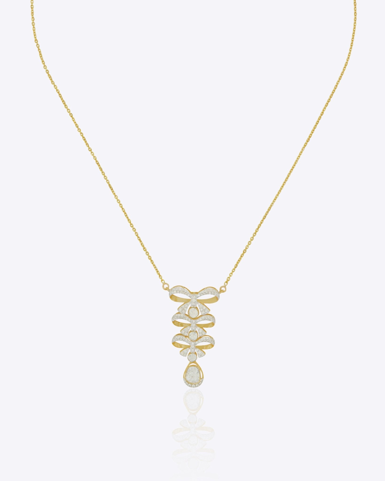 14K gold necklace with a playful tiered bow design and refined finish creating a modern and elegant statement.
