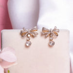 14kt gold bow-inspired drop earrings with delicate design
