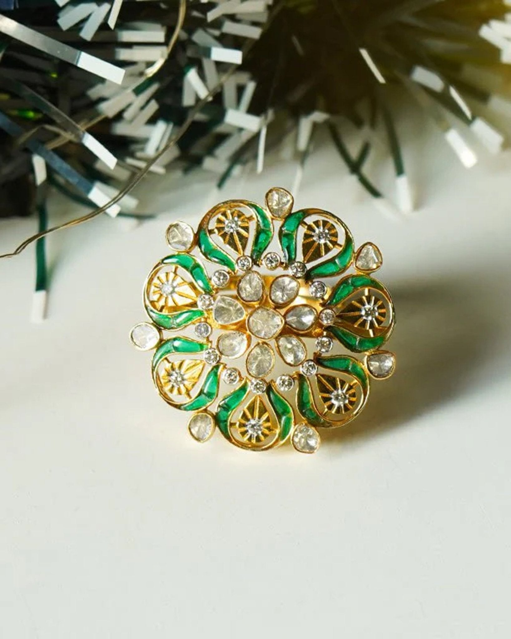 14K gold ring with a green talaf stone centerpiece and Polki diamonds.