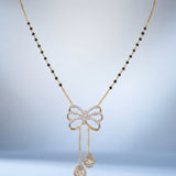 14K gold mangalsutra with Polki detailing and onyx accents