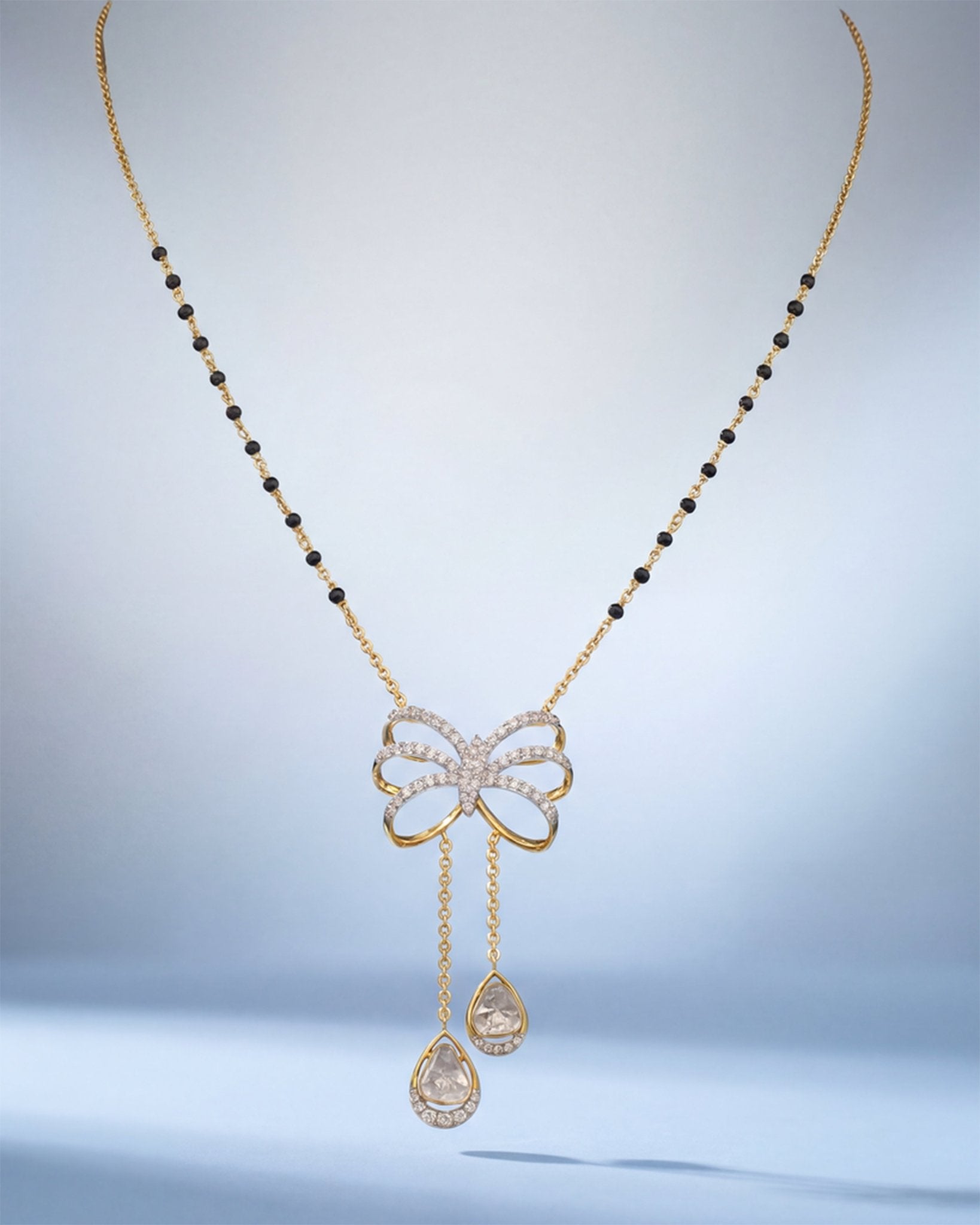 14K gold mangalsutra with Polki detailing and onyx accents
