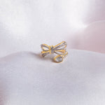 14k gold ring with a sleek, minimalist bow silhouette.