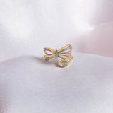 14k gold ring with a sleek, minimalist bow silhouette.
