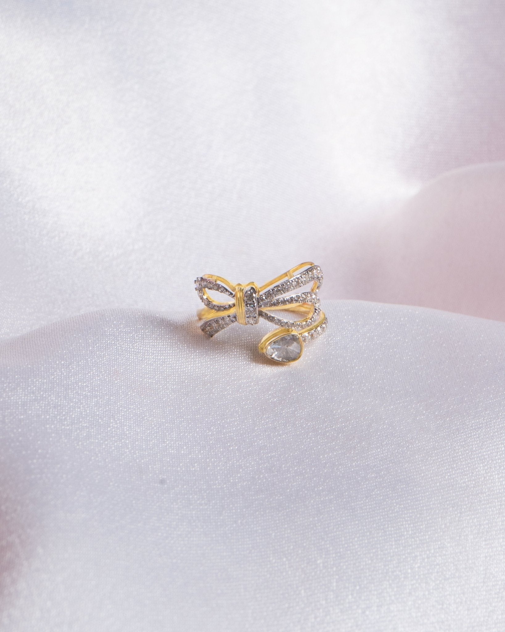 14k gold ring with a sleek, minimalist bow silhouette.