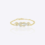 14K gold bracelet with a delicate chain and elegant knot centerpiece creating a minimal and sophisticated look.