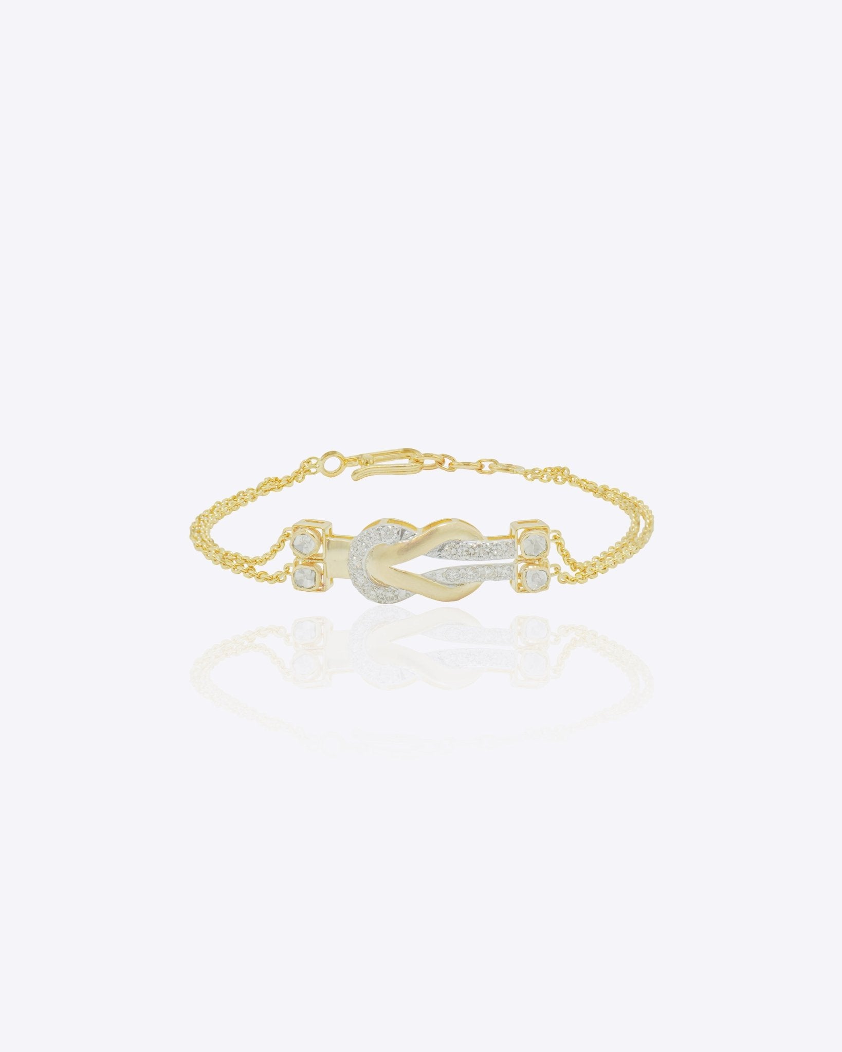 14K gold bracelet with a delicate chain and elegant knot centerpiece creating a minimal and sophisticated look.