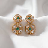 18K gold earrings with a central Polki diamond surrounded by vibrant emeralds.