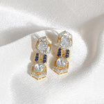 18K gold hexagonal earrings with Polki and vibrant talaf stone accents.