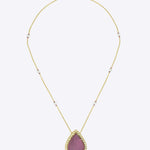 14K gold pendant with a pear-shaped pink tourmaline centerpiece.