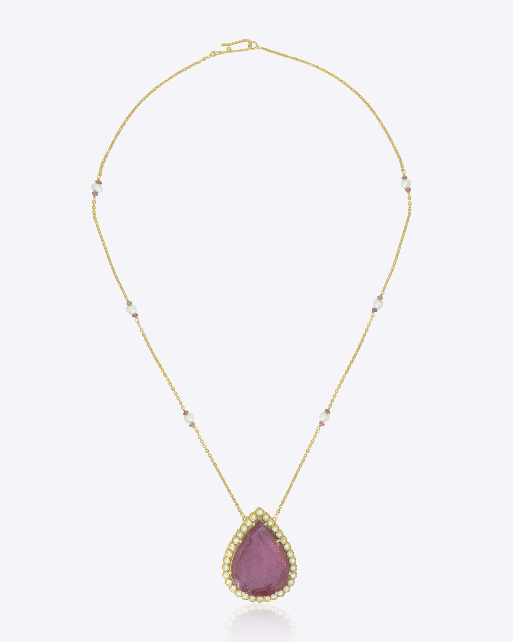 14K gold pendant with a pear-shaped pink tourmaline centerpiece.