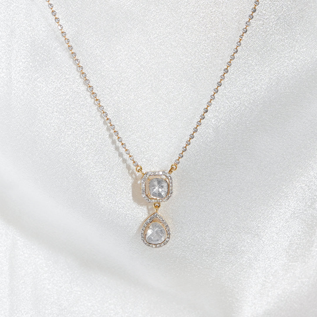 Delicate pendant with two shimmering polki diamonds suspended from a dainty chain.