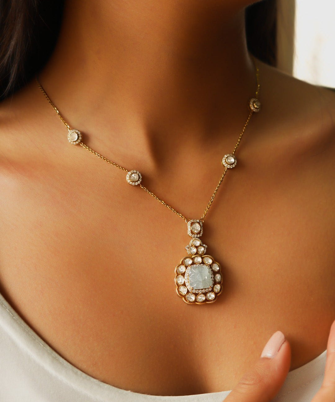 Serene Waters necklace on model featuring serene blue aquamarines and polki accents