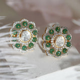 14K gold floral drop earrings set with Polki diamonds and emerald accents.