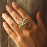 14K gold ring with a green talaf stone centerpiece and Polki diamonds.
