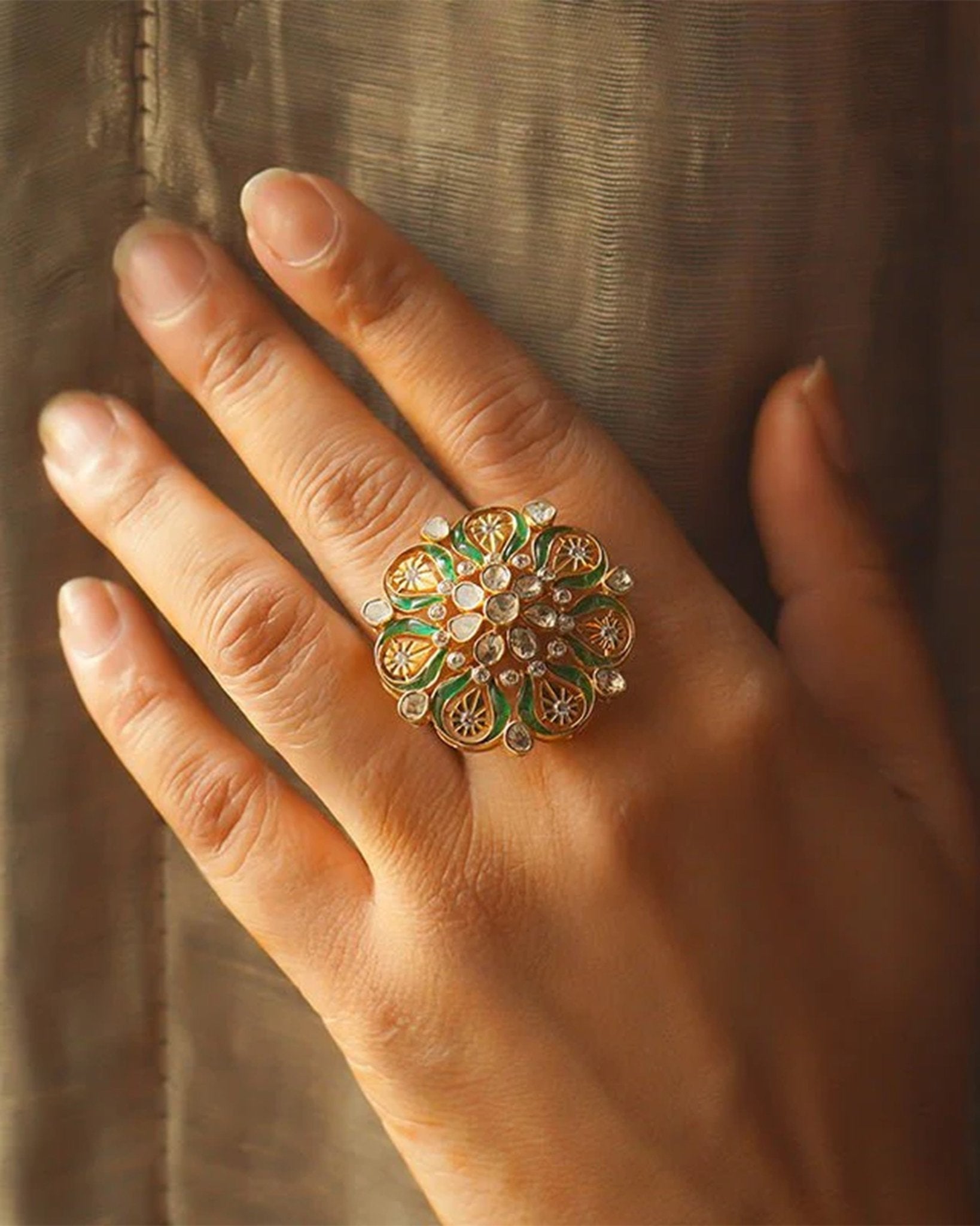 14K gold ring with a green talaf stone centerpiece and Polki diamonds.