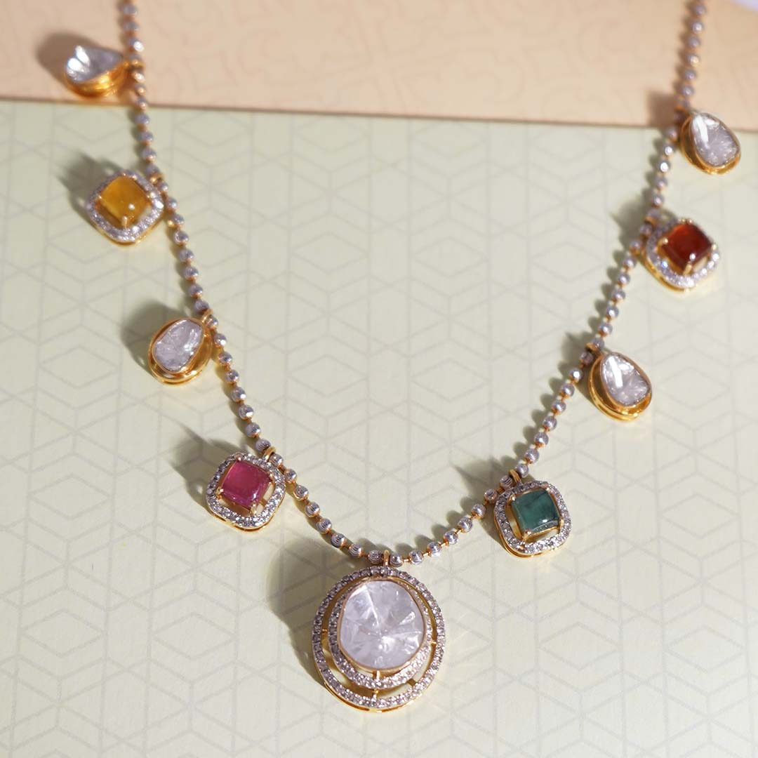 A modern masterpiece with polki diamonds and two colored stones on a gold thread.