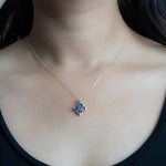 9kt gold pendant with deep blue enamel in a delicate charm shape