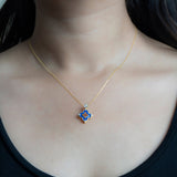 9kt gold pendant with deep blue enamel in a delicate charm shape