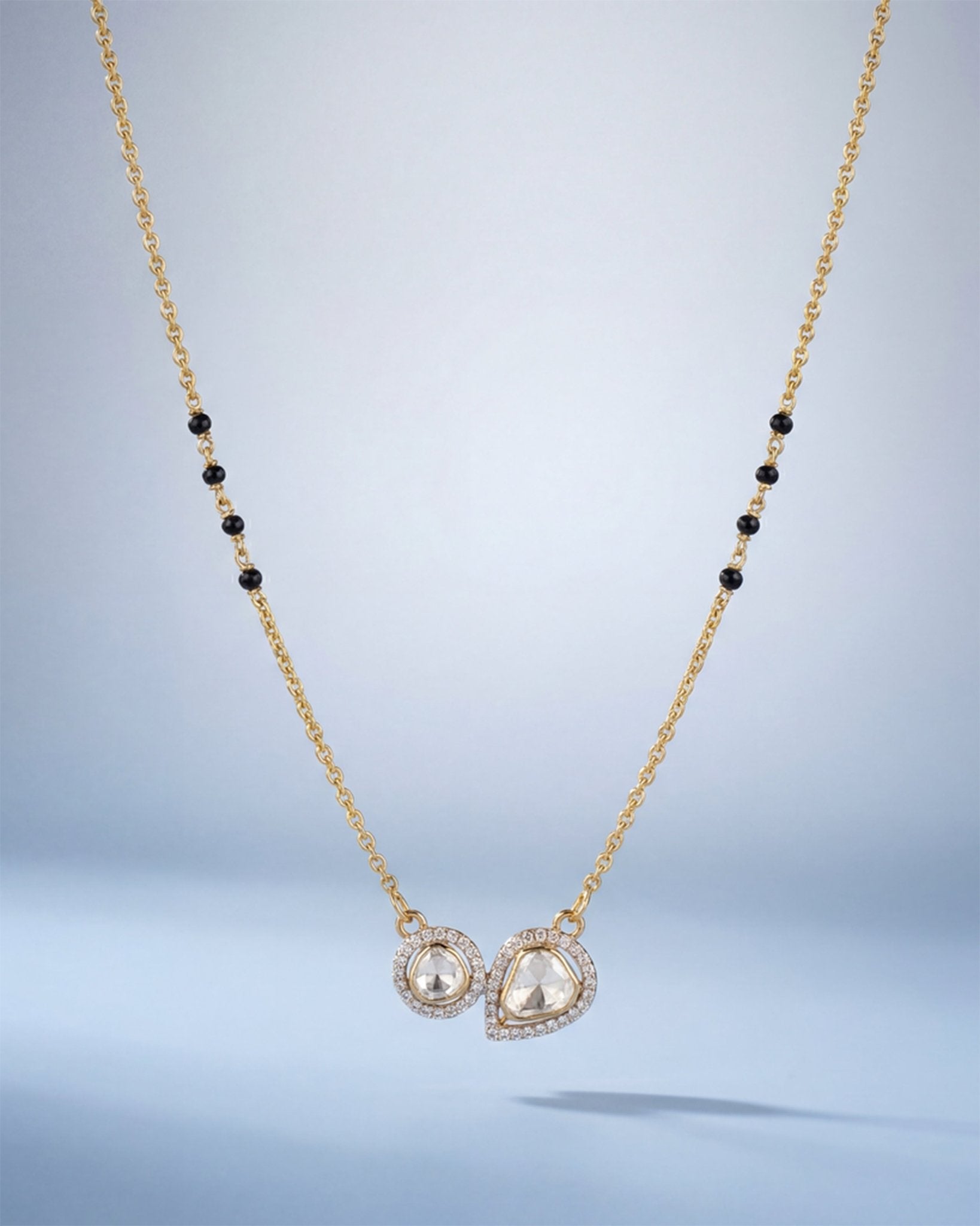 14K gold mangalsutra with round and oval Polki charms