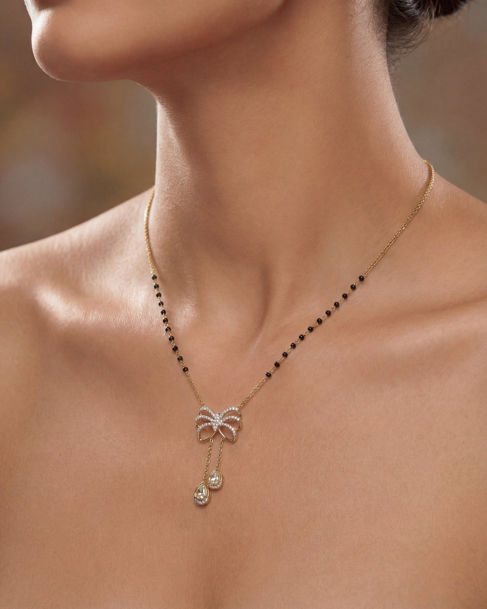 14K gold mangalsutra with Polki detailing and onyx accents